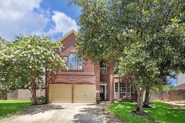 view of front of house featuring a garage and a front lawn