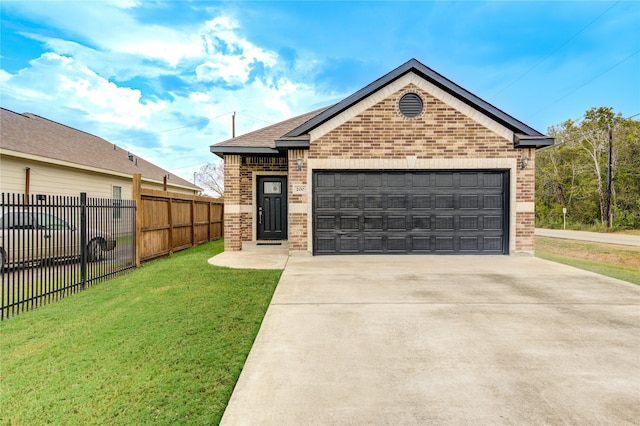 view of front of property featuring a garage and a front lawn