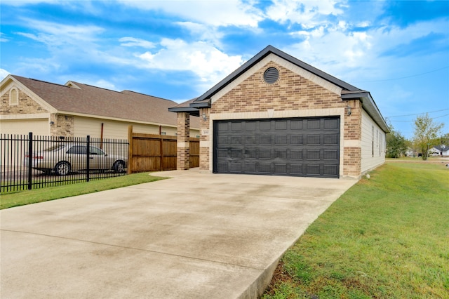 view of front of home with a front yard and a garage