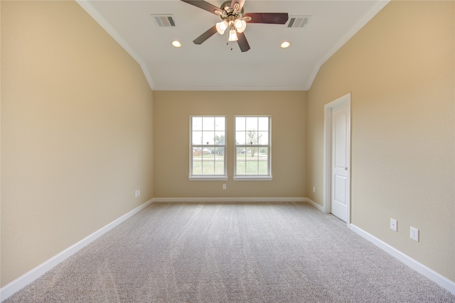 carpeted empty room featuring ornamental molding, ceiling fan, and vaulted ceiling