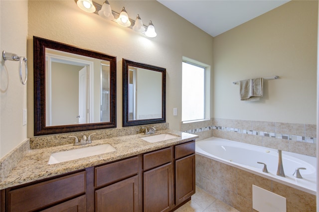 bathroom with tile patterned floors, vanity, and a relaxing tiled tub