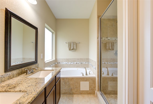 bathroom with tile patterned flooring, vanity, and plus walk in shower