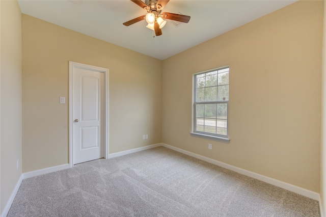 carpeted empty room featuring ceiling fan