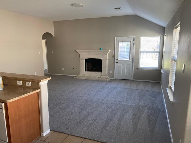 unfurnished living room featuring lofted ceiling and carpet floors