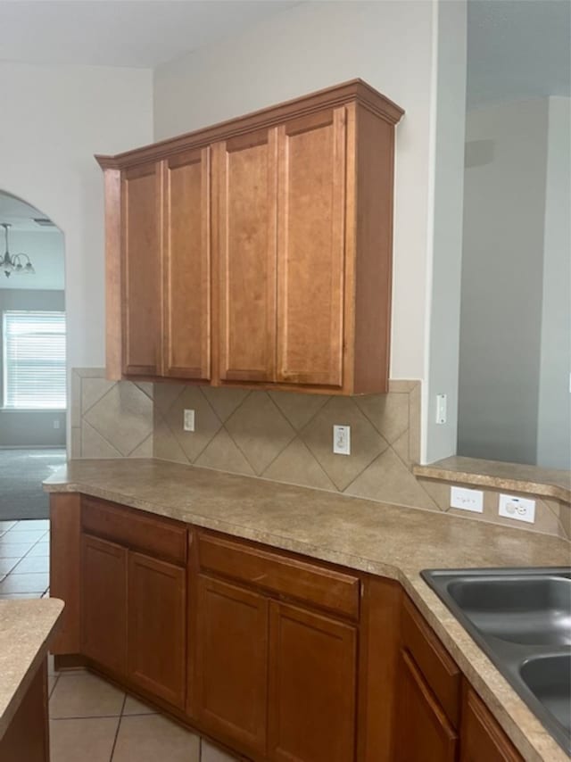 kitchen with sink, backsplash, and light tile patterned floors