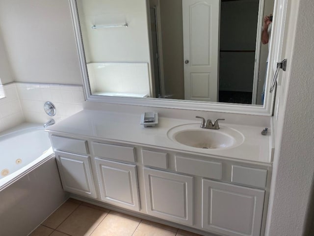 bathroom featuring vanity, a tub to relax in, and tile patterned floors