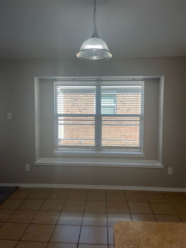 unfurnished dining area with tile patterned floors