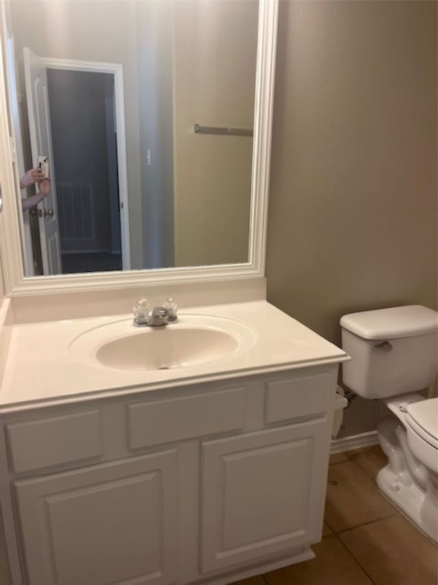 bathroom with vanity, toilet, and tile patterned flooring