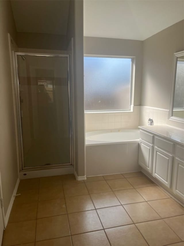 bathroom with vanity, plus walk in shower, and tile patterned flooring