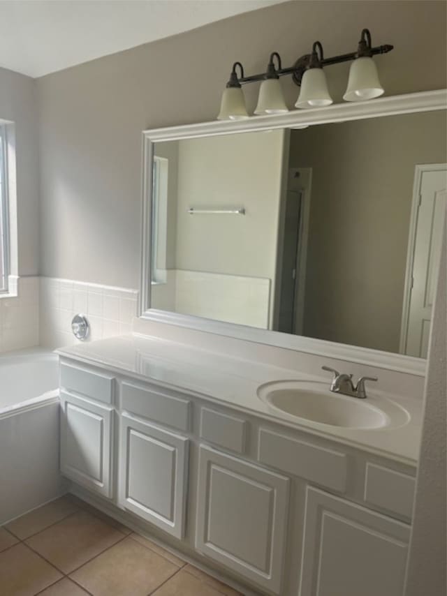 bathroom featuring vanity, a bathtub, and tile patterned flooring