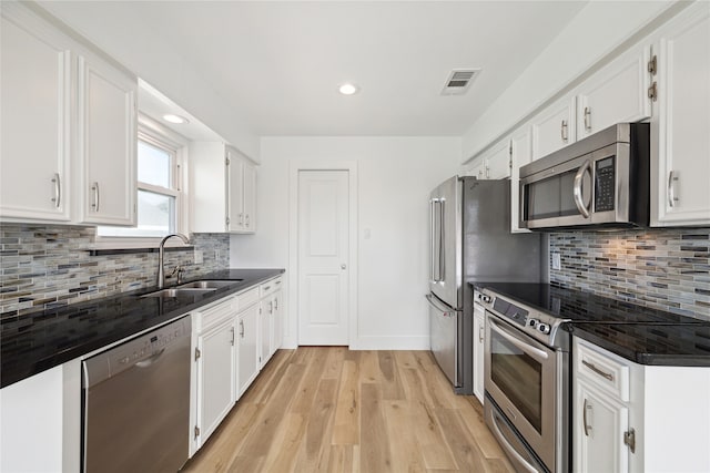 kitchen with sink, stainless steel appliances, light hardwood / wood-style flooring, and white cabinets