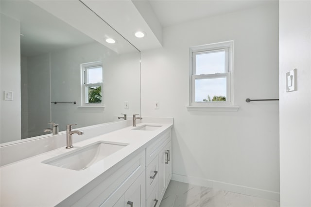 bathroom featuring a wealth of natural light and vanity