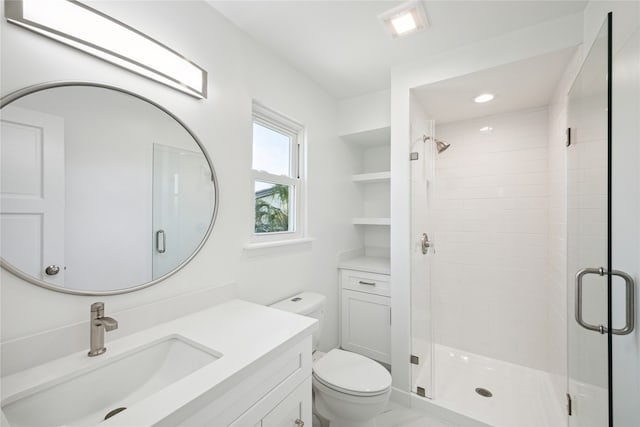 bathroom with vanity, toilet, and an enclosed shower