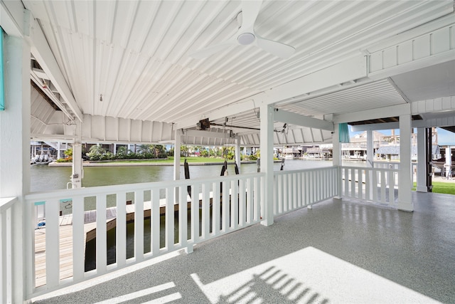 view of patio with a water view and ceiling fan