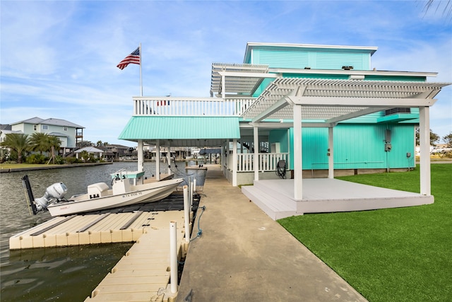 rear view of property featuring a lawn and a water view