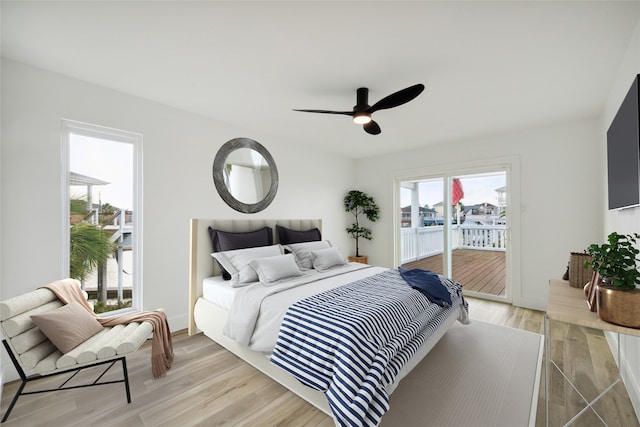 bedroom featuring access to exterior, light hardwood / wood-style floors, and ceiling fan