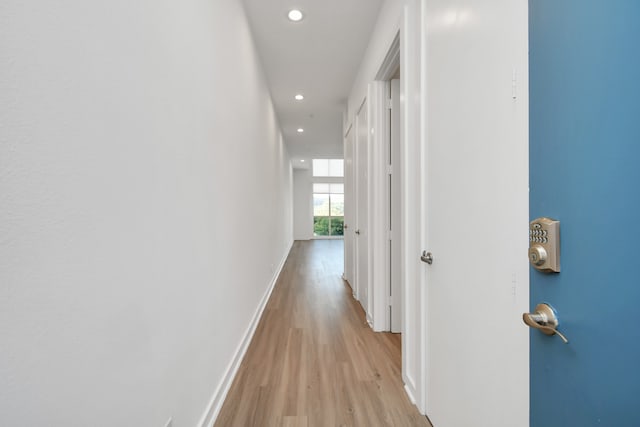 corridor with light wood-type flooring