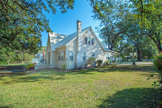 view of side of home featuring a lawn