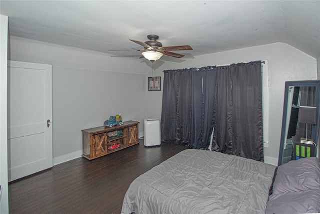 bedroom with ceiling fan, vaulted ceiling, and dark hardwood / wood-style flooring