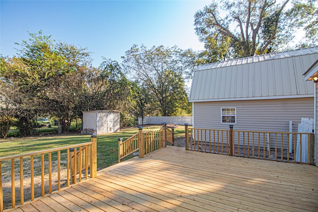 wooden deck featuring a yard and a shed