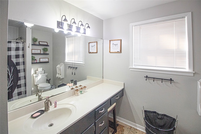 bathroom featuring vanity, toilet, and tile patterned flooring