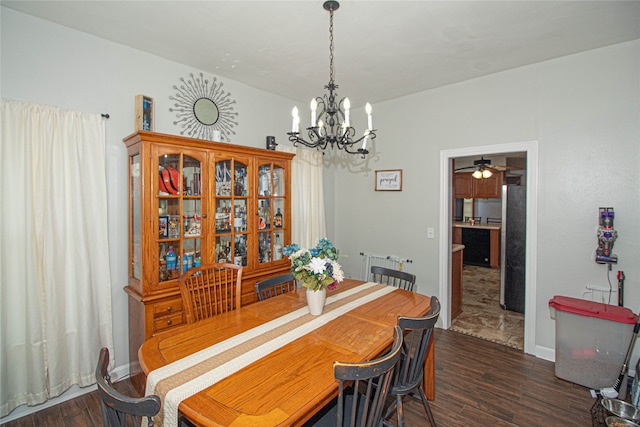 dining space with dark hardwood / wood-style floors and ceiling fan with notable chandelier