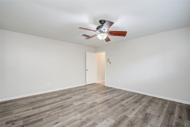 empty room featuring light wood-type flooring and ceiling fan