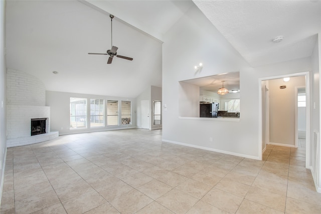 unfurnished living room featuring high vaulted ceiling, light tile patterned floors, a fireplace, and ceiling fan