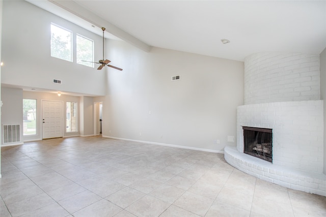 unfurnished living room with light tile patterned floors, a brick fireplace, high vaulted ceiling, and ceiling fan