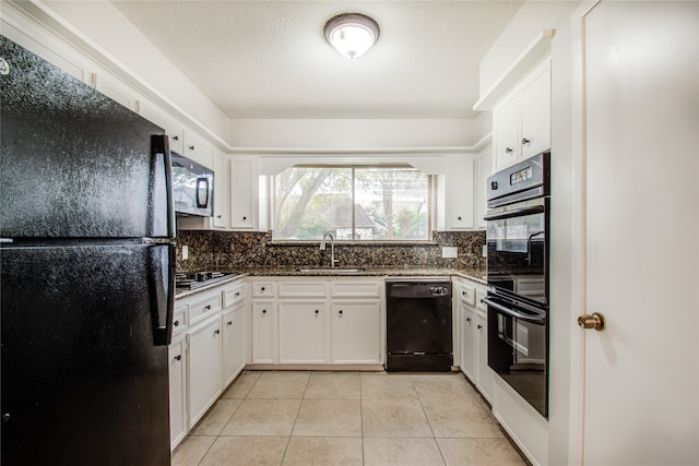 kitchen featuring tasteful backsplash, black appliances, sink, white cabinets, and light tile patterned floors