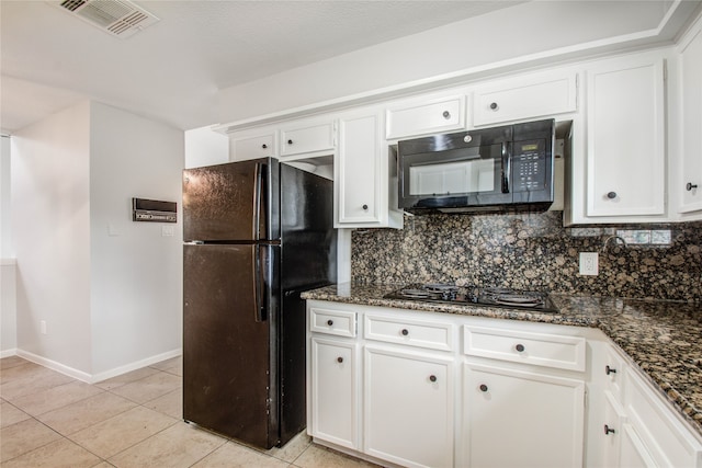 kitchen featuring backsplash, dark stone counters, black appliances, light tile patterned flooring, and white cabinetry