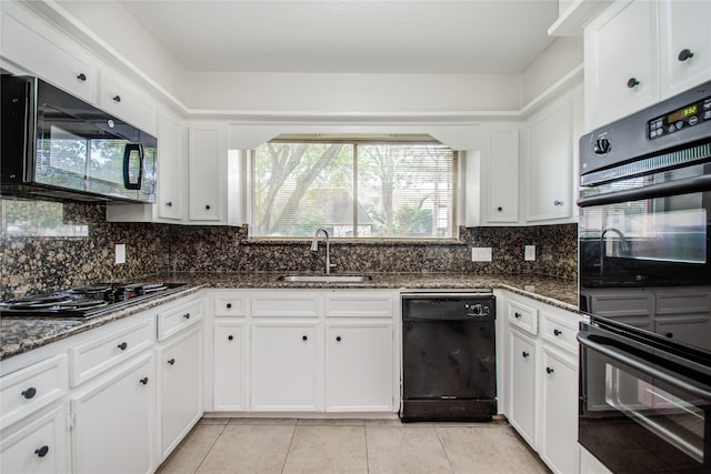 kitchen featuring black appliances, sink, dark stone counters, and white cabinets