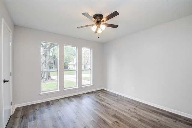 spare room featuring wood-type flooring and ceiling fan