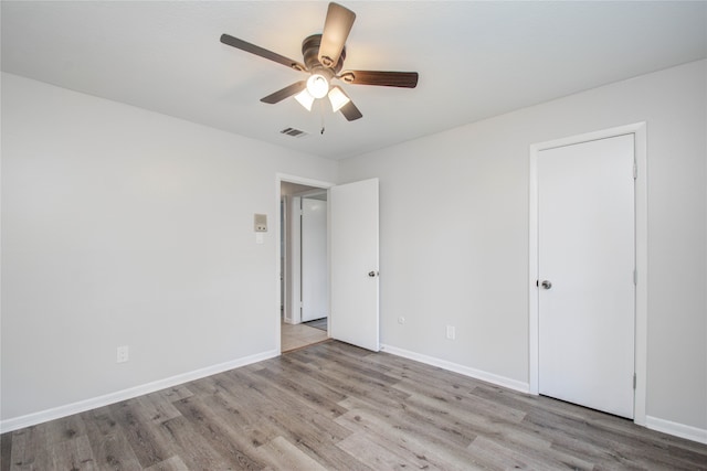 spare room with light hardwood / wood-style floors and ceiling fan