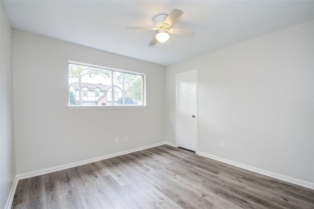 spare room with light hardwood / wood-style floors and ceiling fan