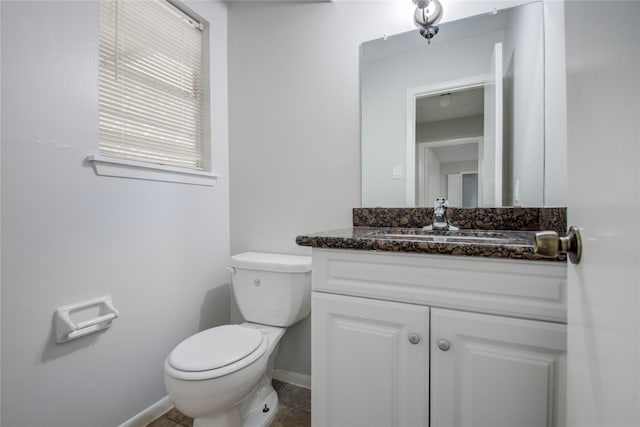 bathroom with vanity, toilet, and tile patterned flooring