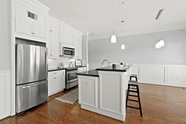 2802 Morrison St Unit 206, Houston, TX 77009 - kitchen with dark countertops, appliances with stainless steel finishes, white cabinetry, and visible vents