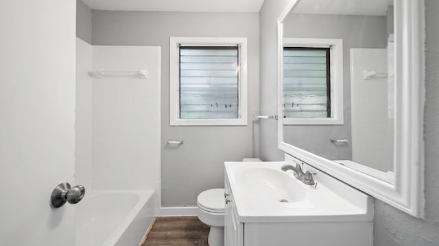 full bathroom featuring vanity, toilet, shower / washtub combination, and hardwood / wood-style floors