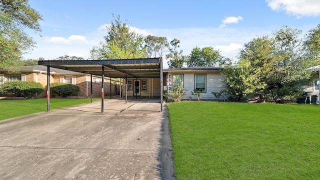 view of front of house with a carport and a front lawn