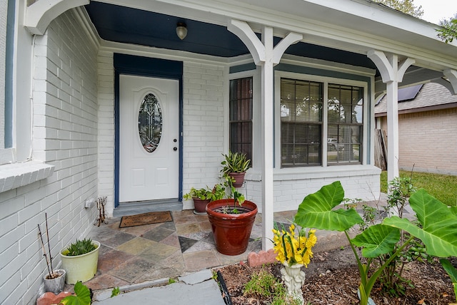 view of exterior entry featuring a porch