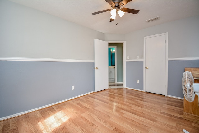 empty room featuring ceiling fan and light hardwood / wood-style flooring