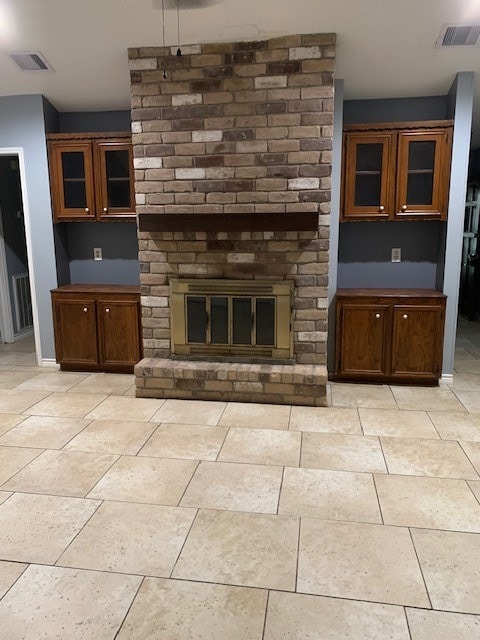 unfurnished living room with a brick fireplace