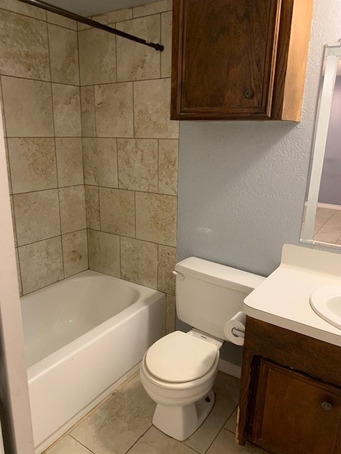 full bathroom featuring vanity, tiled shower / bath combo, toilet, and tile patterned floors