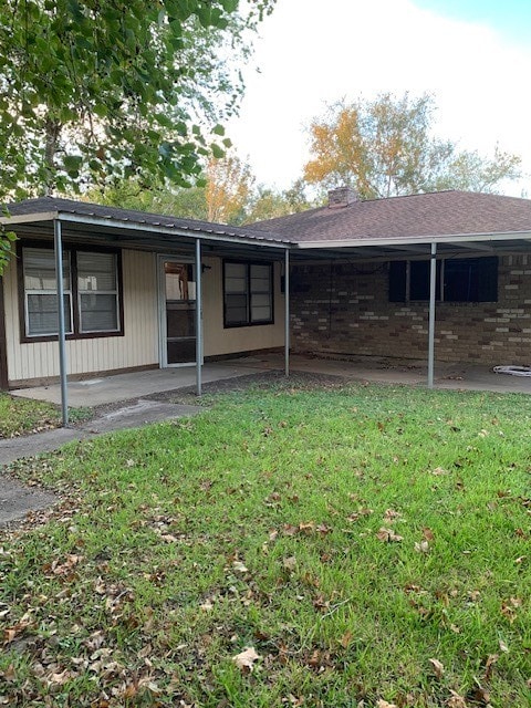 view of front of house with a front lawn and a patio