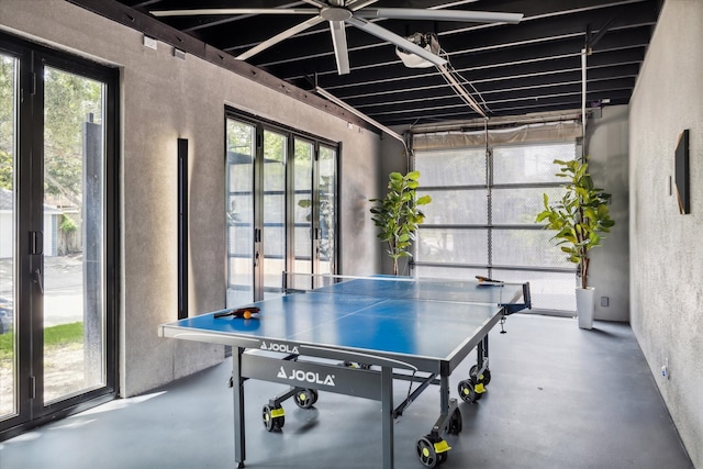 recreation room with a wealth of natural light and concrete floors