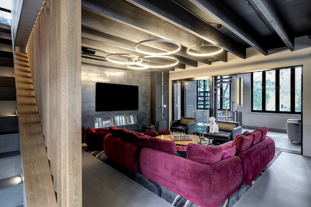 living room with beamed ceiling, concrete flooring, and a fireplace