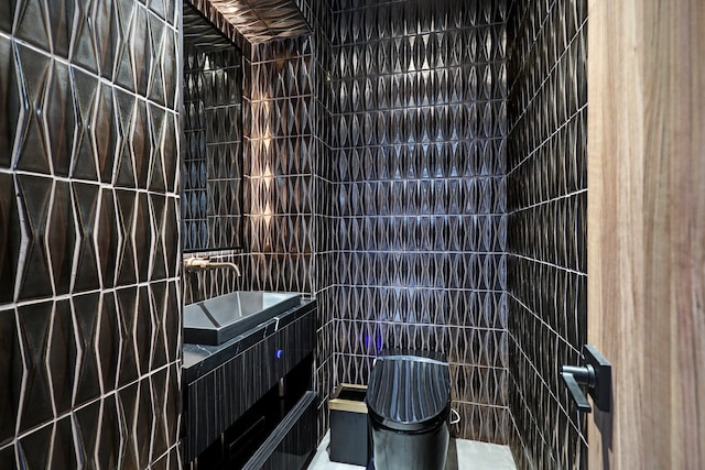 bathroom with tile walls, vanity, and toilet