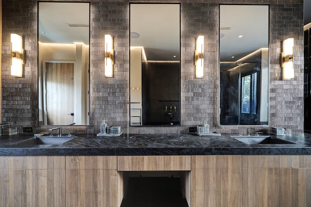 bathroom featuring vanity and decorative backsplash