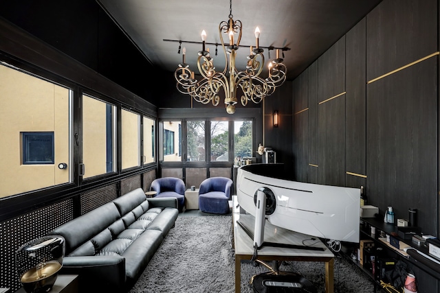 sunroom / solarium featuring a notable chandelier