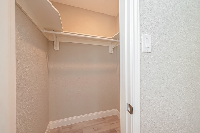 spacious closet featuring light hardwood / wood-style flooring